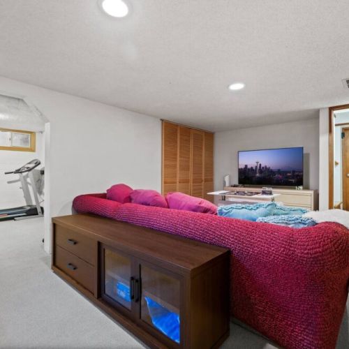 A cinematic entertainment with this smart TV, offering a captivating viewing experience for an unforgettable movie night on the lower level.