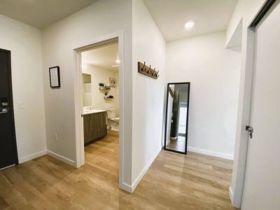 Entryway to the main bathroom and hallway to the en suite queen bedroom.