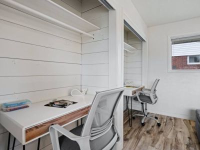 This bedroom also features 2 desk tables and chairs that invite productivity and creativity. This stylish arrangement ensures comfort and inspires productivity.