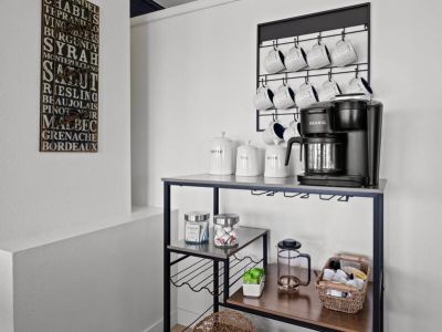 A thoughtfully arranged complimentary tea and coffee station awaits, offering a delightful selection of hot beverages to be enjoyed at any time.
