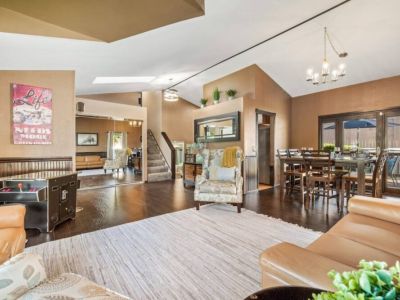 Unwind and engage in friendly competition in the inviting sitting area of the game room, surrounded by a collection of board games and an arcade machine.