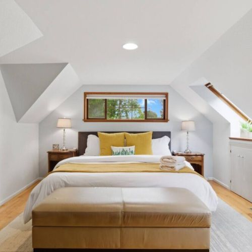 At the "top" of Travelers Treehouse, our King bedroom boasts comfy bedding and plenty of room to relax.