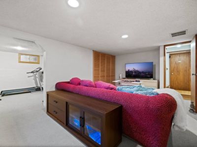 A cinematic entertainment with this smart TV, offering a captivating viewing experience for an unforgettable movie night on the lower level.