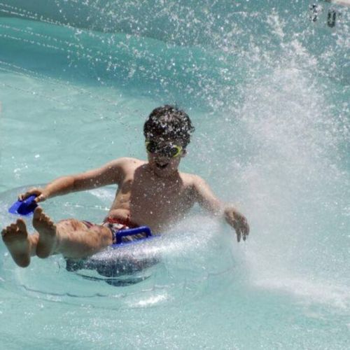 Park swimming pool includes a lazy river feature.