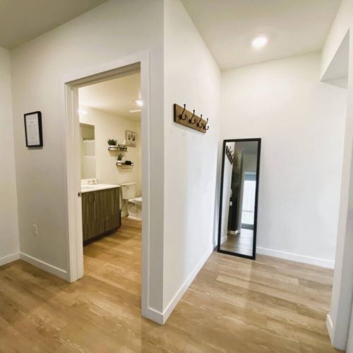 Entryway to the main bathroom and hallway to the en suite queen bedroom.