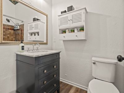 Main Floor Full Bathroom with a tub-shower is located across the hall from the two queen bedrooms