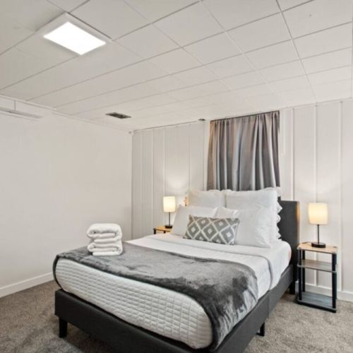 This charming lower level cottage-style bedroom  is tucked away off of the laundry/game room. It includes an office desk and chair, extra pillows and blankets.