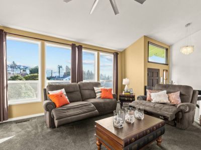 Sit back and relax in the brightly lit living room with electric reclining sofa and chair.