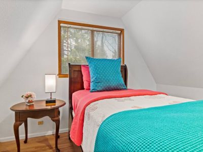 Cozy twin bed is nestled in the Treehouse Loft-snuggle in for a quiet night of rest.