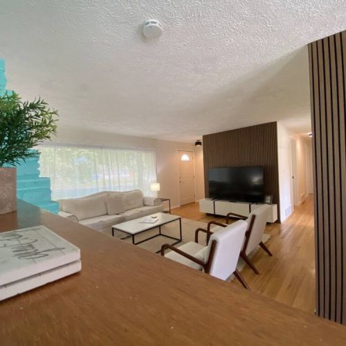 Gather around in the living room with plenty of seating to watch your favorite movies on the 65" Smart TV, work on a puzzle, or just hang out.