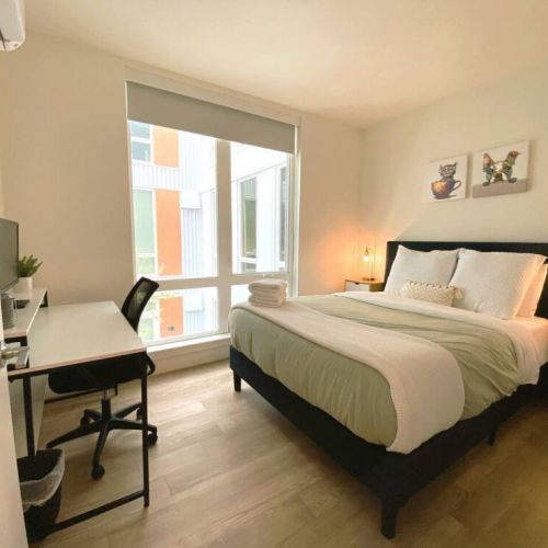 Front queen bedroom with office desk and monitor. A quiet room to work.