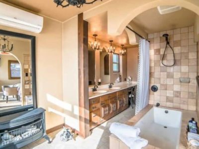 Soak in the deep elongated bathtub while being warmed by the ventless gas fireplace and taking in the water view from the King En Suite Bathroom