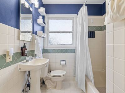 Main floor full bathroom with its original 1945 charm and modern amenities.