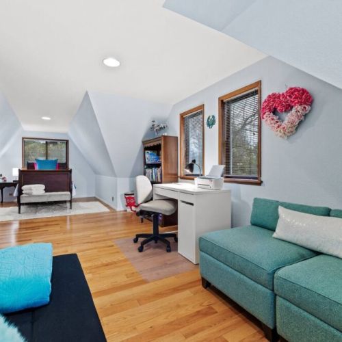 Escape into a cozy retreat with this charming loft twin "nest" bedroom. The unique design and thoughtful layout includes an office desk, chair, games, boks, and a small sofa.