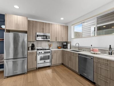 The brightly lit Kitchen has stainless steel applicances with a 4-burner gas range