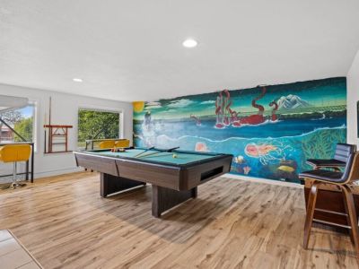 Large game room on the lower level with local artist's mural of Narrows Bridge PNW sealife