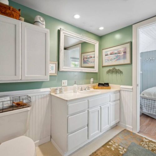Main floor bathroom connects to the Queen bedroom and hallway.