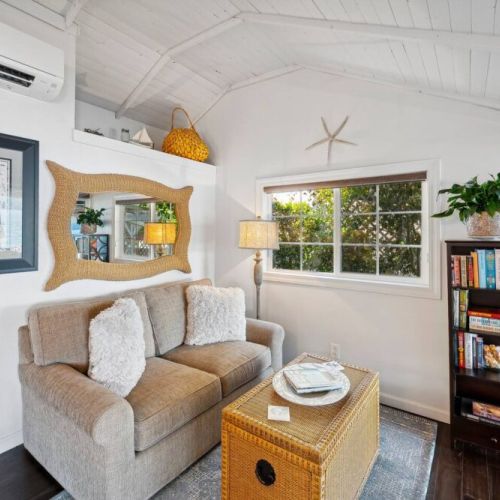 Grab a book and a cup of tea while relaxing in this quaint sitting room just off of the kitchen while enjoying the view of the covered patio and the breeze coming off of the water.