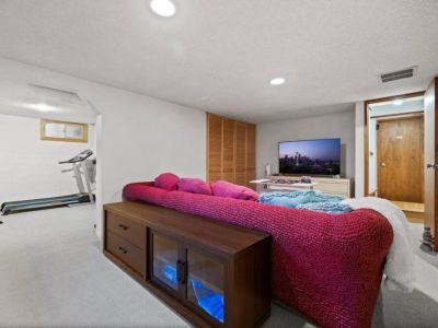 A cinematic entertainment with this smart TV, offering a captivating viewing experience for an unforgettable movie night on the lower level.