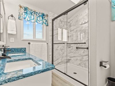 King En Suite Bathroom with large walk-in shower and custom "ocean" quartz countertop.