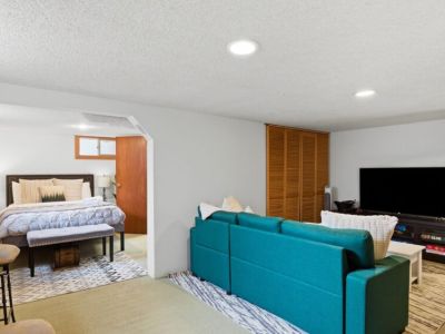 Lower-level game room with queen sleeper sofa and semi-private queen bedroom.