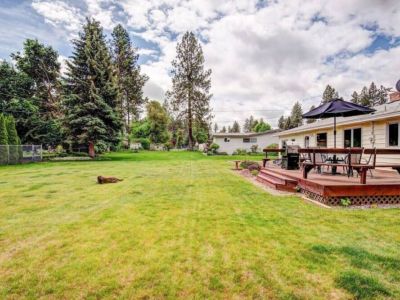 This expansive backyard haven is great for games, gatherings, and grilling out with family and friends...furry friends too!
