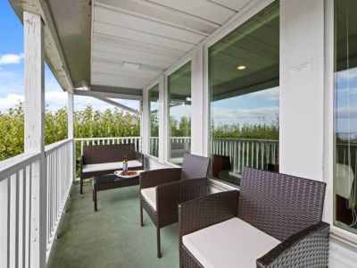 The living room/dining room private balcony is perfect for relaxing with a 4-burner gas grill for outdoor culinary adventures.