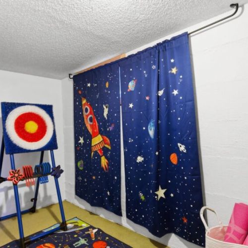 Mini play room has board games, "axe" throwing game, & oversized Connect Four