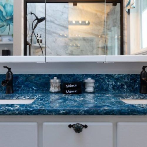 King En Suite bathroom with double vanities and a sky light.