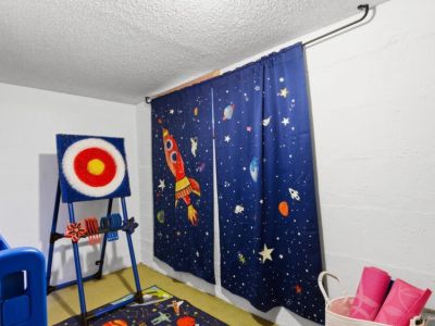 Mini play room has board games, "axe" throwing game, & oversized Connect Four