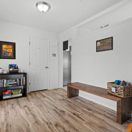 The entryway glows with abundant natural light, creating a warm and inviting atmosphere. Welcome to your home away from home!