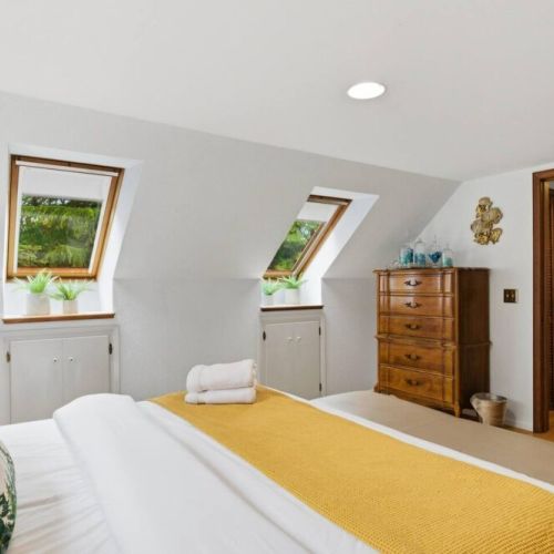 The bedroom is bathed in natural light from angled skylights with views of the treetops. The shades are easily pulled down for darkening the room...or leave up to sleep "under the stars".