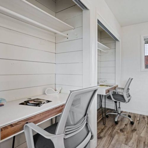 This bedroom also features 2 desk tables and chairs that invite productivity and creativity. This stylish arrangement ensures comfort and inspires productivity.