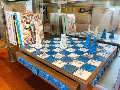 The lighted bookcase has several books and games to choose from.