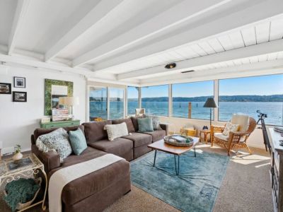 This coastal haven boasts an expansive floor-to-ceiling window that opens up to a mesmerizing ocean view, instantly drawing you into its serene embrace.