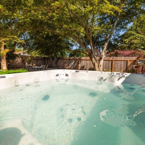 Hot tub view of the spacious backyard