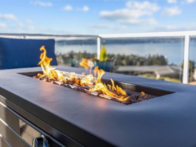 Lounge by the elongated fire pit with breathtaking views of Commencement Bay, Browns Point Lighthouse, Vashon Island, and the Olympic Mountains
