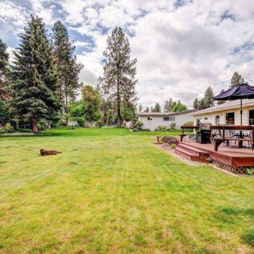 This expansive backyard haven is great for games, gatherings, and grilling out with family and friends...furry friends too!