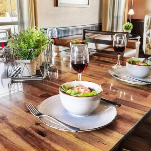 The warm and inviting ambiance of the room is enhanced by soft lighting and tasteful decor, creating the perfect setting for intimate dinners or lively gatherings.