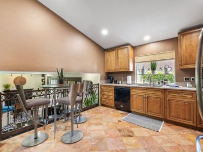 Discover the heart of the home in this well-equipped kitchen featuring a charming coffee nook, perfect for your morning brew. The kitchen offers a spacious layout and modern appliances for preparing delicious meals.