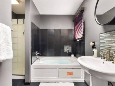 Step into a world of relaxation and luxury in the en suite bathroom of the king bedroom, featuring a jetted Jacuzzi tub and a separate shower.