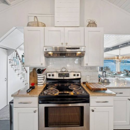 Prepare a gourmet meal or simply enjoy a morning cup of coffee, this modern white kitchen is a symphony of form and function, where simplicity meets sophistication, making every culinary endeavor a delightful experience.