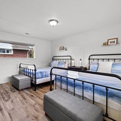 A generously spacious bedroom features two comfortable Queen beds, providing ample space for relaxation and rejuvenation.