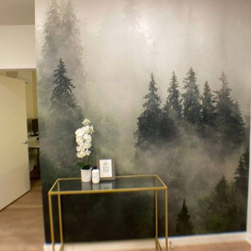 As you step through the door, the entryway transforms into an artistic gateway, adorned with a captivating wall mural that sets the tone for the entire space