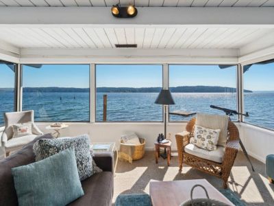 As you gaze out through the window, the rhythmic sound of waves crashing against the shore provides a soothing soundtrack to your relaxation...