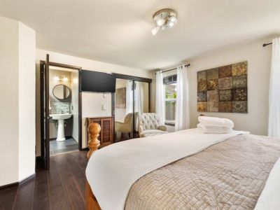 Indulge in the ultimate comfort and convenience in this en suite king bedroom, featuring a 42" smart TV, spacious double closet with a Graco Pack n Play. Take a much deserved break in the chair with ottoman.
