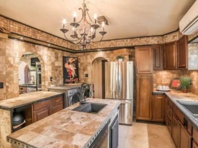 The Prep Kitchen is adjacent to the Chef's Kitchen and includes a second refrigerator, dishwasher, two sinks, large pantries, and front loading washer and dryer.