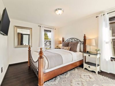 Experience serene comfort in this Queen bedroom adorned with soft creams and greys, creating a soothing and inviting ambiance. Unwind as you enjoy your favorite shows on the 42" Smart TV, and conveniently charge your devices with the USB lamps.