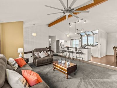 Open Concept Great Room has additional seating at the kitchen island and comfortable reclining sofa and chair.