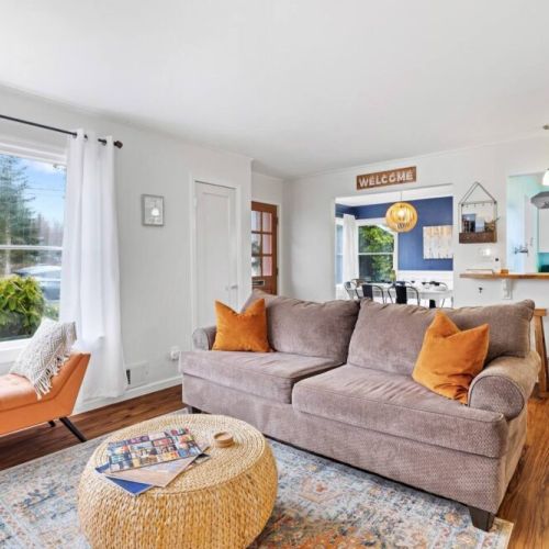 Welcome to our sunlit living room, where large windows bathe the space in abundant natural light. Bask in the glow of the sun as you unwind in this light-filled haven.